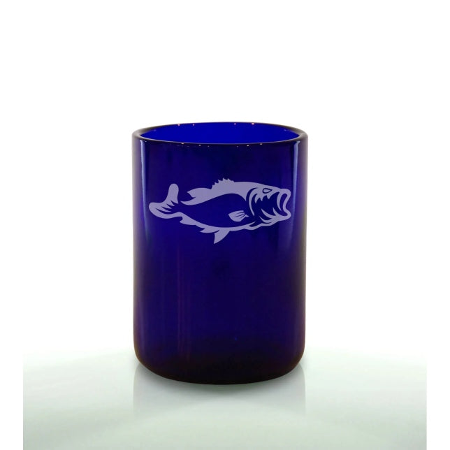 A blue glass with a white engraved design of a fish.